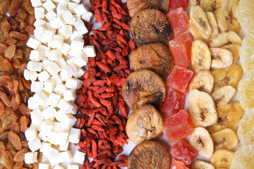 Different tasty dried fruits as background, top view