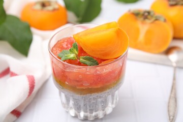 Delicious dessert with persimmon and chia seeds on table