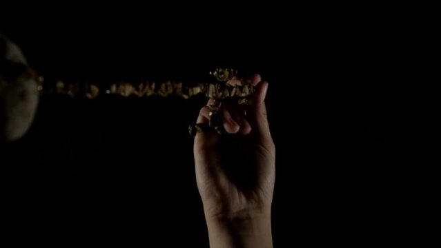 Up view of the hands holding pendulum