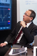 Portrait of skilled business analyst using charts. Serious Caucasian man looking at digital screen...