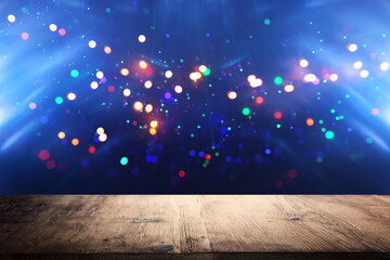 Empty table in front of christmas glitter bokeh background with colorful lights. Ready for product...