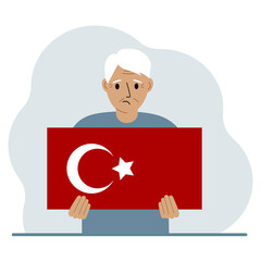 A man holds a Turkish flag in his hands. Concept for demonstration, national holiday, Turkey day or patriotism. Nationality.
