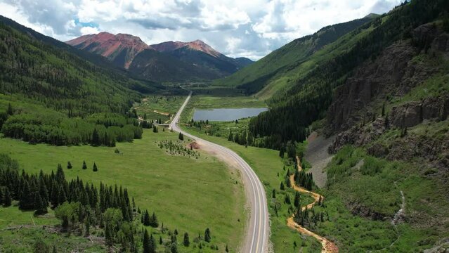 Mineral Creek Staging Area on Million Dollar Highway, Colorado USA. Aerial View of Empty Road, Lake and Green Hills