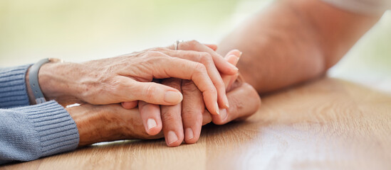 Senior, holding hands and support with couple, comfort and help on table for grief, pain or...