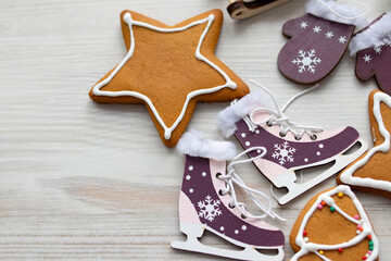 festive gingerbread and New Year's toys lie on a light wooden background.Top view