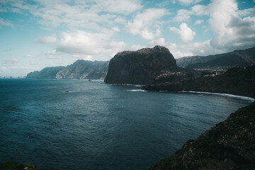 a large body of water with mountains in the background on madeira, portugal