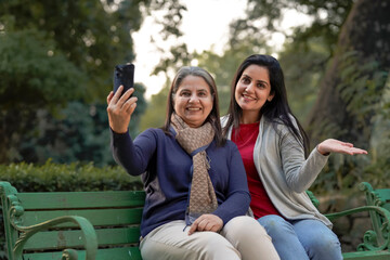 Two indian woman taking selfie at park