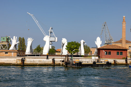  Giant joined hands sculpture Building Bridges by Lorenzo Quinn. Exhibition at Arsenale, Castello, Venice