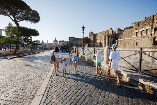 Fototapeta Family tourists walking in street Via dei Fori Imperiali in Rome, Italy.