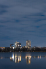 Naklejka premium Scenic view of the city of Dnepr in the winter evening. Dnipro in the evening. Ukrainian city in winter at night. background image. Panoramic view. Long exposure photo of the Dnieper River at night.