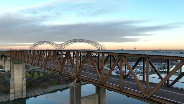 Mud Island State Park in Memphis Tennessee. Rising aerial reveals Hernando de Soto bridge over Mississippi River at sunrise.