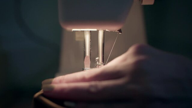 A close-up of a woman using a sewing machine