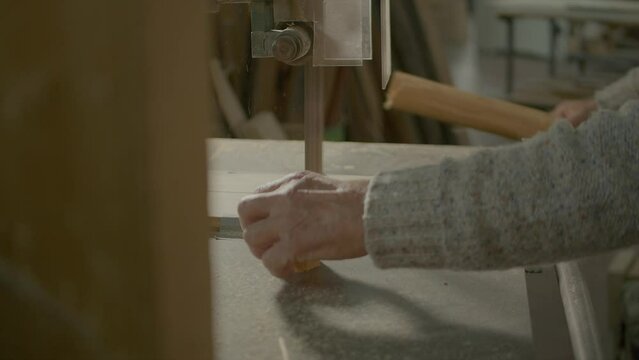 Close Shot Of Wood Artisan Cutting Carefully Little Piece Of Trunk 