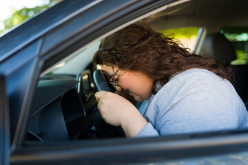 Fototapeta na wymiar Stressed fat woman angry while driving