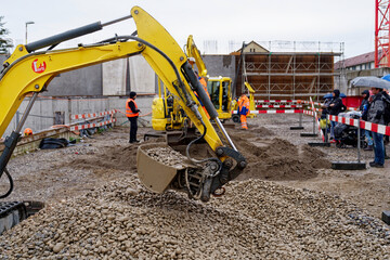 Open day at highway enclosure construction site at Zürich Schwamendingen with excavator exercising...