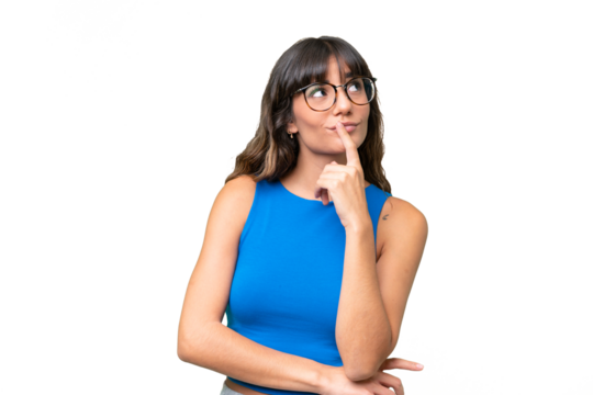 Young caucasian woman over isolated background having doubts while looking up