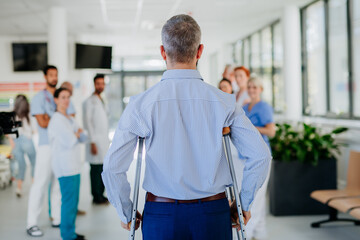 Medical staff clapping to patient who recovered from serious accident.
