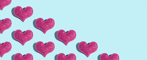 Banner from pattern made from glitter heart shape on colored background with hard shadow. Valentines day minimalistic design