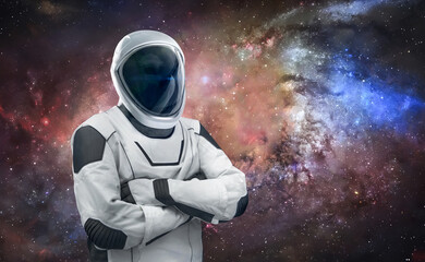 Astronaut stand on space background with stars. Spaceman in spacesuit. Cosmic sci-fi wallpaper. Elements of this image furnished by NASA