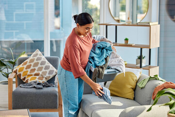 Woman, laundry and house for cleaning, happy and fresh scent in living room. Latino female, maid...