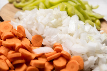 Chopped fresh peppers, onions, carrots. Vegetarianism concept. Mix of vegetables.