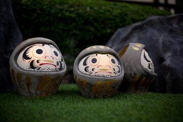 Darumas in the grass