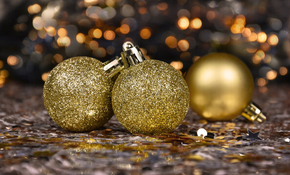 Beautiful golden Christmas glitter balls with bokeh lights stock images. Shiny luxury golden christmas baubles still life stock photo images