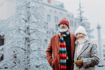 Senior couple walking in winter city center.