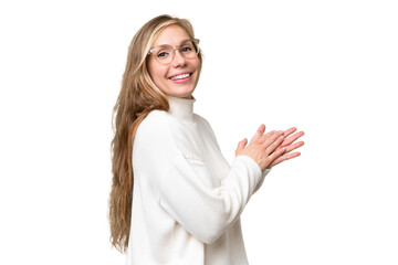 Young blonde woman over isolated background applauding