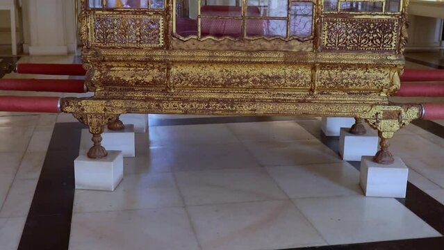 antique golden palanquin kept at fort from different angle shot is taken at Daulat Khana (Treasury) mehrangarh fort jodhpur rajasthan india on 06 sep 22.