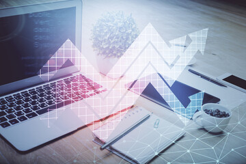 Computer on desktop with point up arrows hologram. Double exposure. Concept of success.