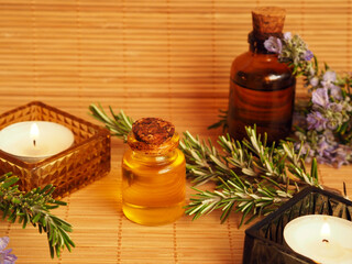 Rosemary essential oil, fresh rosemary sprigs, candles