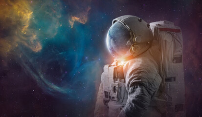 Astronaut in deep space. Science space art. Creative surreal wallpaper. Spaceman in bright galaxy. Elements of this image furnished by NASA