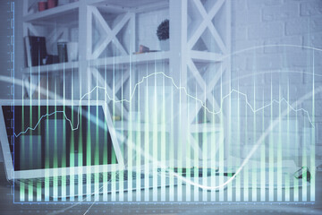 Stock market graph on background with desk and personal computer. Double exposure. Concept of financial analysis.