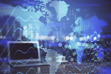 Stock market graph on background with desk and personal computer. Double exposure. Concept of financial analysis.