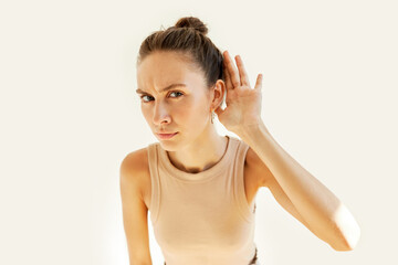 Pretty young girl eavesdropping, listening to rumors and gossips about herself attentively,...