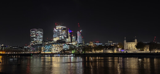 Night view of London part of the capital of Great Britain with the River Thames and the new skyscrapers of The City.