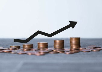 Pile of coins with red arrows showing percentages on the table. The Financial Crisis About Inflation. the concept of higher price inflation and more expensive food