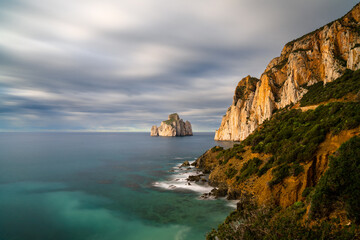 Fototapeta na wymiar long exposure of the Porto Flavia coast in Sardinia with the Pan di Zucchero sea stack