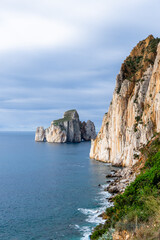 Fototapeta na wymiar vertical landscape of the cliffs and sea stacks at Porto Flavia on Sardinia