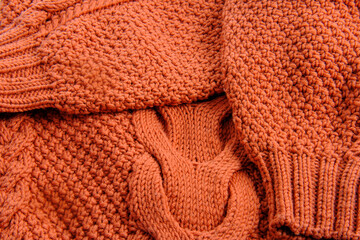 wool knitted sweater in carrot color with a large structure