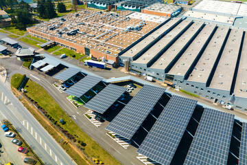 Aerial view of solar panels installed as shade roof over parking lot with parked cars for effective...