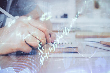 Multi exposure closeup hands with stock market forex graph.