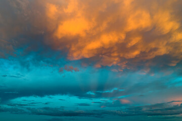 Colorful evening landscape with soft pastel coloured clouds on watercolor tinted sunset sky. Abstract nature background