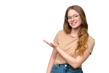 Young pretty woman over isolated background presenting an idea while looking smiling towards