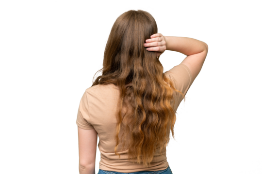 Young pretty woman over isolated background in back position and thinking