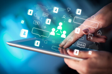 Close-up of a hand using tablet, social media concept