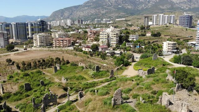 Drone photo of Mahmutlar and Kargicak Alanya districts with view of Naula Ancient City remains.