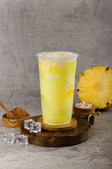 Boba or tapioca pearls is taiwan bubble milk tea in plastic cup with Pineappple flavor on texture ...
