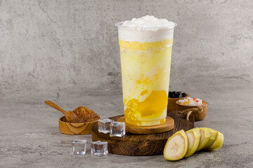 Boba or tapioca pearls is taiwan bubble milk tea in plastic cup with Banana flavor on texture ...